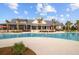 Resort-style pool featuring palm trees, lounge chairs, and a clubhouse in a bright, inviting community setting at 357 Parish Farms Dr, Summerville, SC 29486