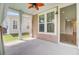Relaxing screened-in porch with a decorative fan, neutral tones, and an entrance into the main house at 357 Parish Farms Dr, Summerville, SC 29486