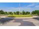 Scenic roundabout with an American flag, lush landscaping, trees and sidewalks at 357 Parish Farms Dr, Summerville, SC 29486