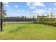 A tennis court is nestled in a green landscape with mature trees at 357 Parish Farms Dr, Summerville, SC 29486