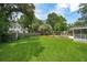 Backyard featuring a refreshing pool surrounded by lush greenery and a storage shed near a neighboring house at 43 Heathwood Dr, Charleston, SC 29407
