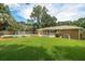 Backyard featuring a refreshing pool surrounded by lush greenery, a brick home, and a cozy screened-in porch at 43 Heathwood Dr, Charleston, SC 29407