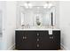 Elegant bathroom featuring a sleek double vanity, contemporary fixtures, and patterned wallpaper at 43 Heathwood Dr, Charleston, SC 29407