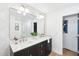Modern bathroom showcasing a double vanity, stylish wallpaper, and a framed mirror at 43 Heathwood Dr, Charleston, SC 29407