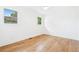Bright bedroom with light hardwood floors, white trim, and two windows offering natural light at 43 Heathwood Dr, Charleston, SC 29407