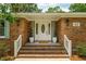 Inviting front entrance featuring a classic white door, elegant plants, and brick steps at 43 Heathwood Dr, Charleston, SC 29407