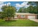 Charming brick home with a well-manicured lawn, mature tree, and an attached two-car garage at 43 Heathwood Dr, Charleston, SC 29407