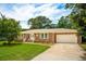 Beautiful brick home featuring a lush green lawn, large tree, and a convenient two-car garage at 43 Heathwood Dr, Charleston, SC 29407