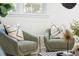 Close up of living room seating, with stylish pillows, patterned rug, and ample light at 43 Heathwood Dr, Charleston, SC 29407