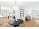 Open living space with modern decor, including a dining table and a view of the stylish white kitchen at 43 Heathwood Dr, Charleston, SC 29407
