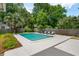 Backyard in-ground pool surrounded by a concrete deck, wooden fence, and lush green landscaping at 43 Heathwood Dr, Charleston, SC 29407