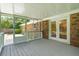 Enclosed porch features neutral flooring, white trim, and backyard access at 43 Heathwood Dr, Charleston, SC 29407
