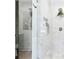 Beautiful shower with marble-look tiles, glass door, built-in niche, and a rainfall showerhead at 43 Heathwood Dr, Charleston, SC 29407