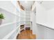 Bright walk-in closet featuring custom shelving and hardwood floors offers ample storage space and style at 43 Heathwood Dr, Charleston, SC 29407