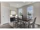 Bright dining room featuring a dark wood table and six chairs beneath two windows at 430 Caledon Court Ct, Johns Island, SC 29455