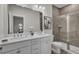 Modern bathroom with double sinks, granite countertops, and a glass-enclosed shower at 469 Caledon Ct, Johns Island, SC 29455