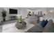 Cozy living room with a modern sofa, stylish coffee table, and an open layout connecting to the kitchen at 475 Caledon Ct, Johns Island, SC 29455