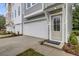 Home's entrance with doormat, one-car garage, and nicely trimmed landscape at 501 Caledon Ct, Johns Island, SC 29455