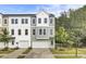 Two-story townhome with neutral siding, double-hung windows, and attached one-car garage at 501 Caledon Ct, Johns Island, SC 29455