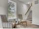 Cozy living area with accent chairs, a window, and a staircase in a bright room at 501 Caledon Ct, Johns Island, SC 29455
