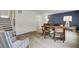 Bright home office area with a desk, blue accent wall, and stairs at 501 Caledon Ct, Johns Island, SC 29455