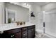 Bathroom with a double vanity, dark cabinets, and a glass-enclosed shower at 503 Caledon Court Ct, Johns Island, SC 29455