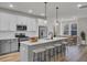 Modern kitchen with white cabinets, stainless appliances, large island and adjacent dining area at 503 Caledon Court Ct, Johns Island, SC 29455