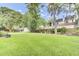 Large backyard with green grass and mature trees, perfect for outdoor activities and enjoying the serene surroundings at 5406 Dwight Dr, North Charleston, SC 29420
