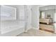 Bathroom featuring a soaking tub, glass-enclosed shower, and a view into the Primary bedroom at 5406 Dwight Dr, North Charleston, SC 29420