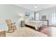 Cozy bedroom with a white bed, rocking chair, area rug, and hardwood floors at 5406 Dwight Dr, North Charleston, SC 29420