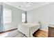 Cozy bedroom with a comfortable bed, wooden floors, ceiling fan and curtains by window at 5406 Dwight Dr, North Charleston, SC 29420