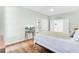 Bedroom featuring a white bed, hardwood floors, neutral walls, and multiple doors at 5406 Dwight Dr, North Charleston, SC 29420