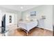 Light and airy bedroom with a white bed, hardwood floors, and peaceful decor at 5406 Dwight Dr, North Charleston, SC 29420