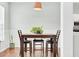 Cozy dining area featuring a wooden table set with chairs, lovely plant and hardwood floors at 5406 Dwight Dr, North Charleston, SC 29420