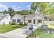 Attractive single-story home featuring a well-kept lawn, palm tree, and spacious driveway at 5406 Dwight Dr, North Charleston, SC 29420
