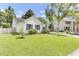 Well-maintained single-story home with lush lawn, driveway, and beautiful landscaping at 5406 Dwight Dr, North Charleston, SC 29420