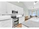 Bright kitchen featuring white cabinets, stainless steel appliances, granite countertops, and a tiled backsplash at 5406 Dwight Dr, North Charleston, SC 29420