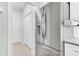 Stainless steel refrigerator with water and ice dispenser, white cabinets, and tile flooring at 5406 Dwight Dr, North Charleston, SC 29420