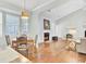 Combined dining and living area featuring hardwood floors and natural light with fireplace in living room at 5406 Dwight Dr, North Charleston, SC 29420