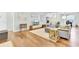 Hardwood floors adorn open living space featuring natural light and seamless flow to dining and kitchen at 5406 Dwight Dr, North Charleston, SC 29420