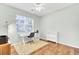 Bright office features a ceiling fan, white desk with chair, bookshelf and a view of the outside at 5406 Dwight Dr, North Charleston, SC 29420