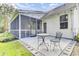 Cozy patio with screened porch, perfect for outdoor dining and relaxation, with string lights, and a well-maintained yard at 5406 Dwight Dr, North Charleston, SC 29420