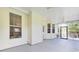 Spacious screened porch with ceiling fans, seating area and access to the backyard at 5406 Dwight Dr, North Charleston, SC 29420
