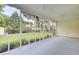 Screened-in porch with a view of the spacious green lawn, shed, and trees at 5406 Dwight Dr, North Charleston, SC 29420