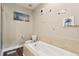 Neutral bathroom with separate tiled tub is decorated with floral accents at 5511 Colonial Chatsworth Cir, North Charleston, SC 29418