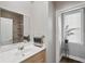 Bright bathroom featuring a modern vanity, decorative mirror, and tiled shower reflected in the mirror at 5511 Colonial Chatsworth Cir, North Charleston, SC 29418