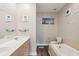 Bathroom featuring double sinks and a separate tiled tub at 5511 Colonial Chatsworth Cir, North Charleston, SC 29418