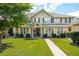 Inviting two-story home with a manicured lawn, charming front porch, and mature landscaping at 5511 Colonial Chatsworth Cir, North Charleston, SC 29418