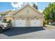 Detached two car garage with white doors and lovely exterior details at 5511 Colonial Chatsworth Cir, North Charleston, SC 29418