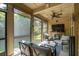 Comfortable screened-in porch with ceiling fan, string lights and view of the lush backyard at 5511 Colonial Chatsworth Cir, North Charleston, SC 29418